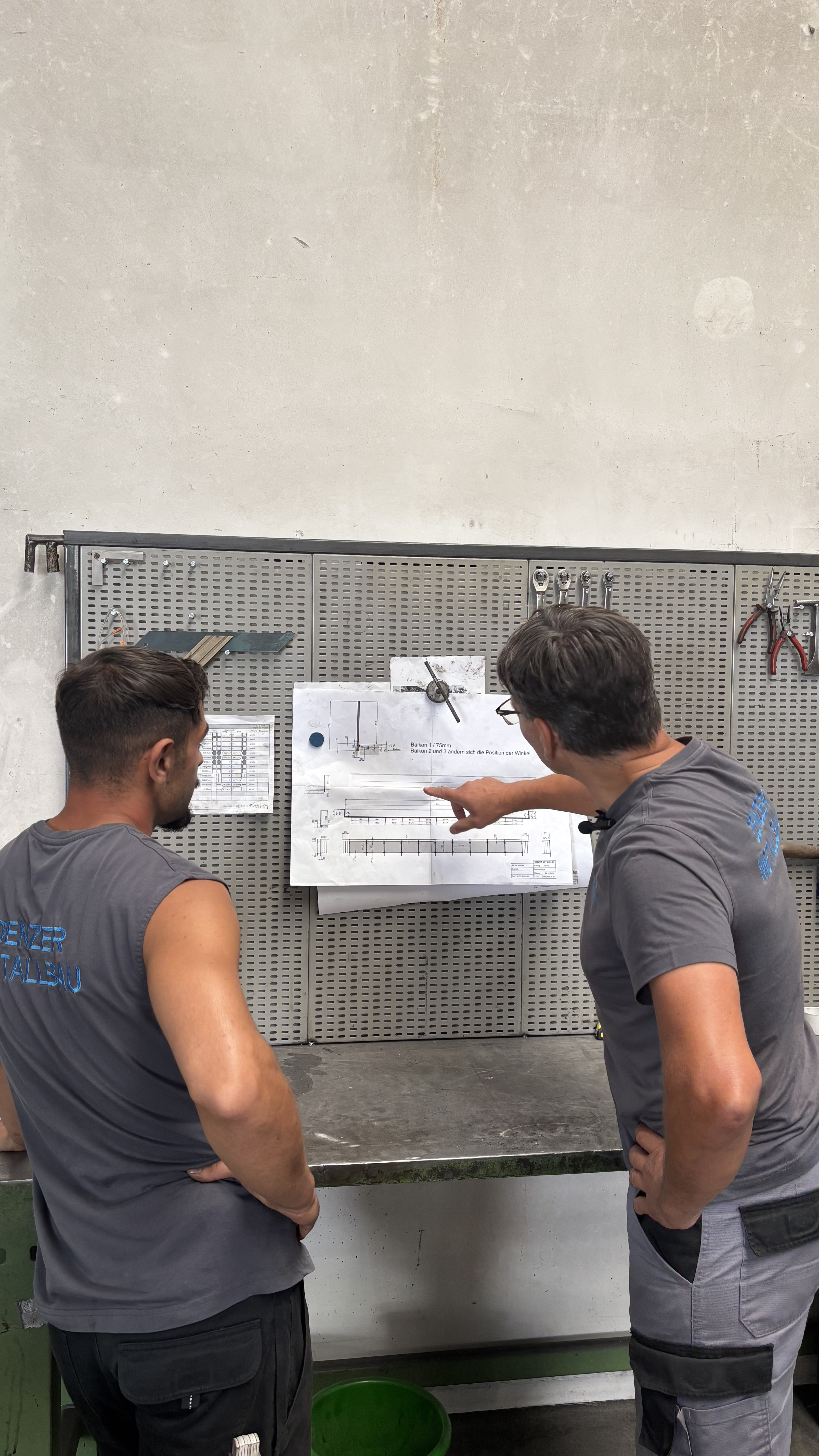 Team bespricht eine Zeichnung in der Werkstatt